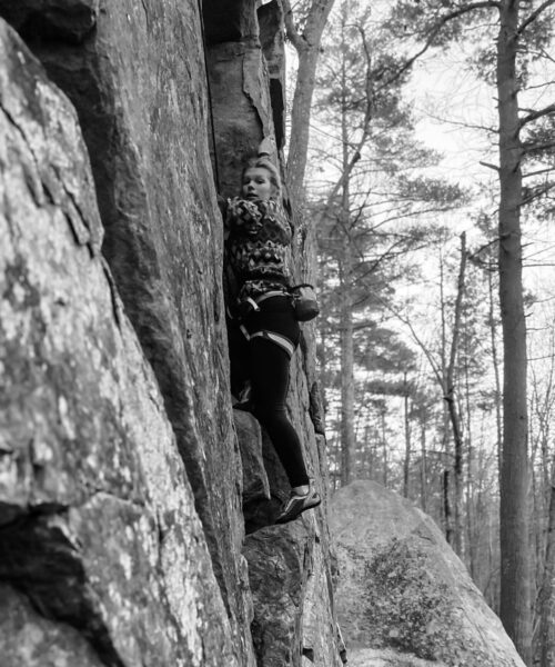 A climber traverses a section of the cliff at Kenyon Hill Preserve.