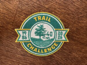 embroidered circular patch that reads "Trail Challenge 40 Years 1986 2026"